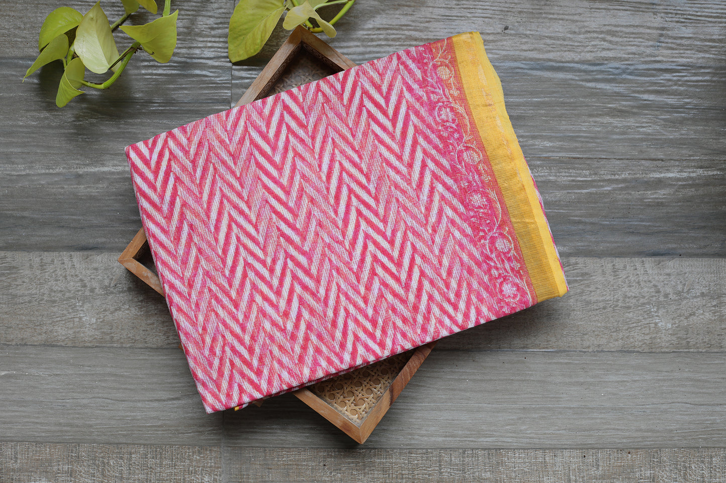 Breezy and playful pink zigzags paired with a bold yellow Bagru-printed border make this Kota Doria saree a charming and elegant choice