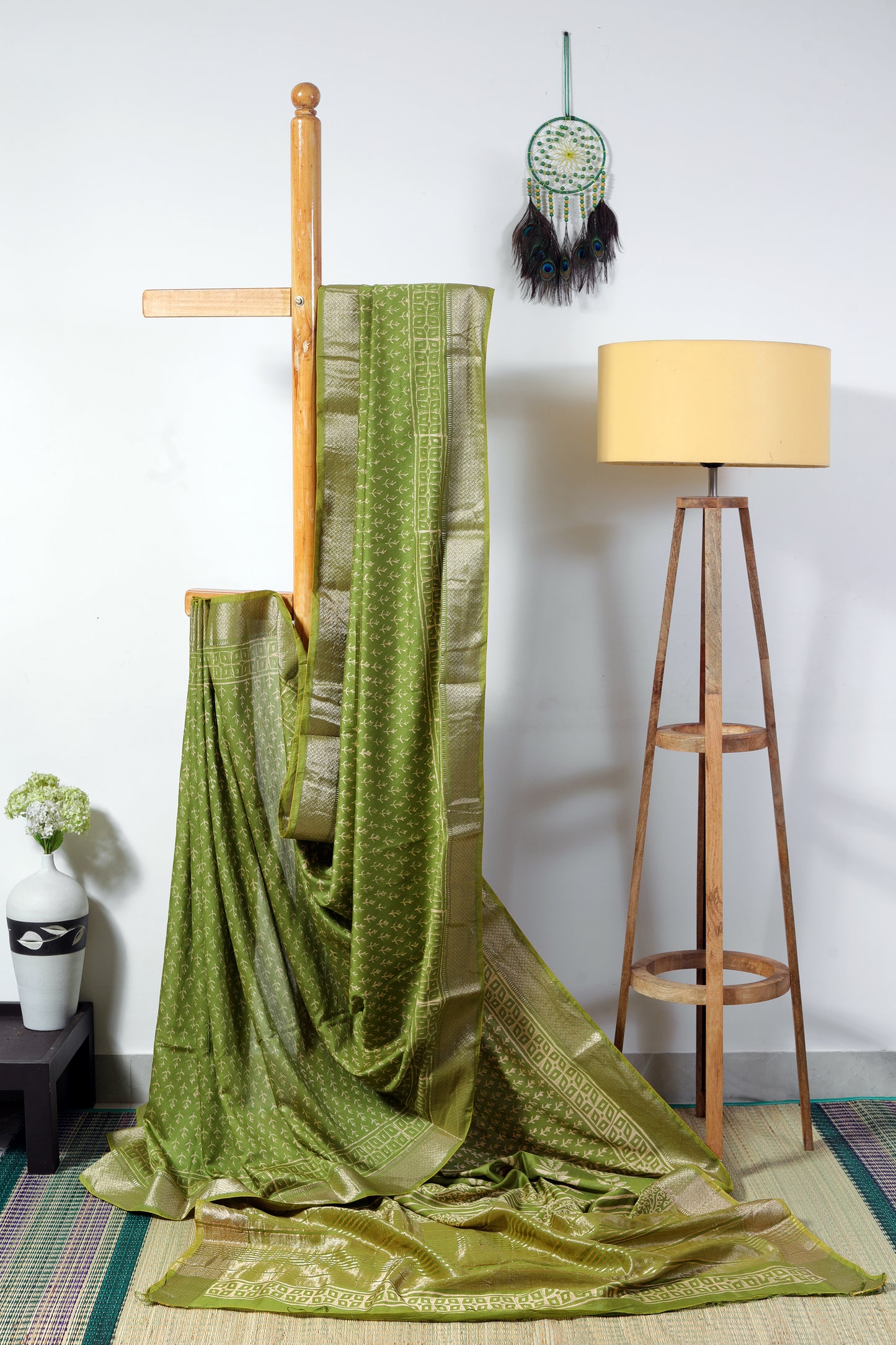art silk maheshwari - green body with small plant like block prints with a zig zag zari border