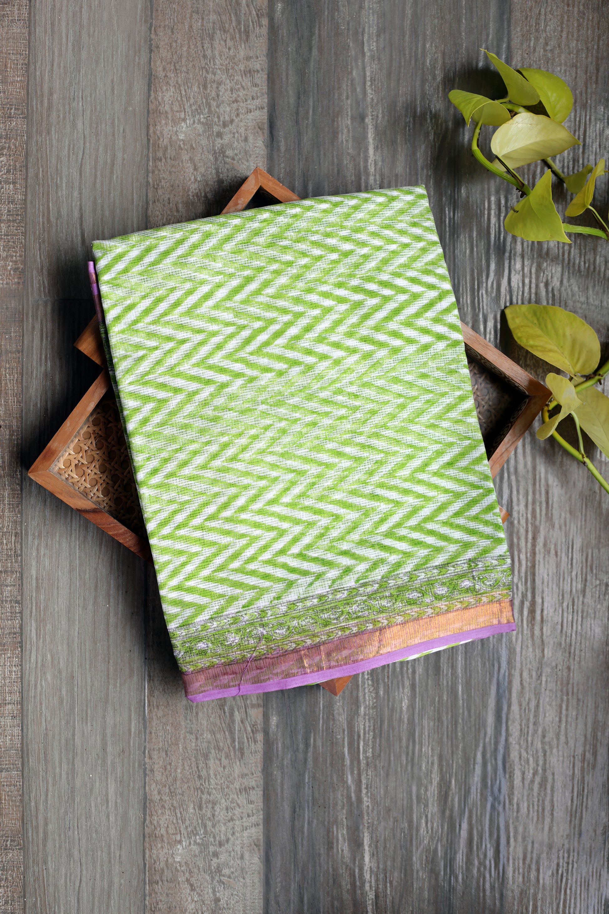 Kota Doria saree adorned with bagru prints in refreshing green zigzag lines, beautifully balanced by a soft lavender border. Light as air, graceful in drape, and effortlessly chic