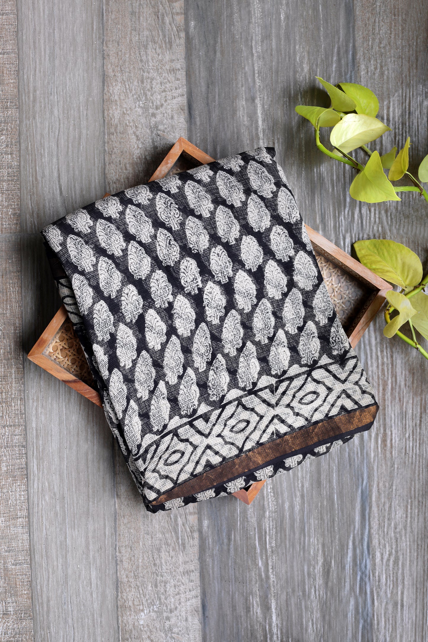Black kota doria saree with leaf like prints in beige and a rust gold