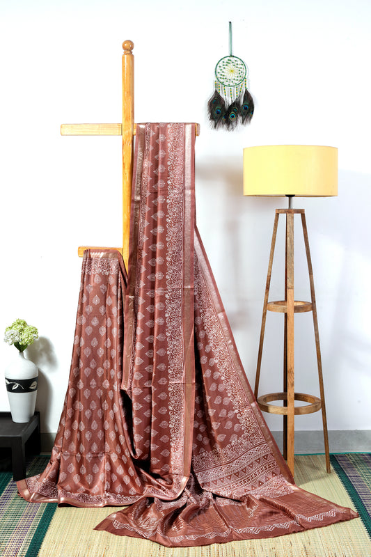 art silk crepe-  brown body with off white leaf block prints finished with a patterned border and zari