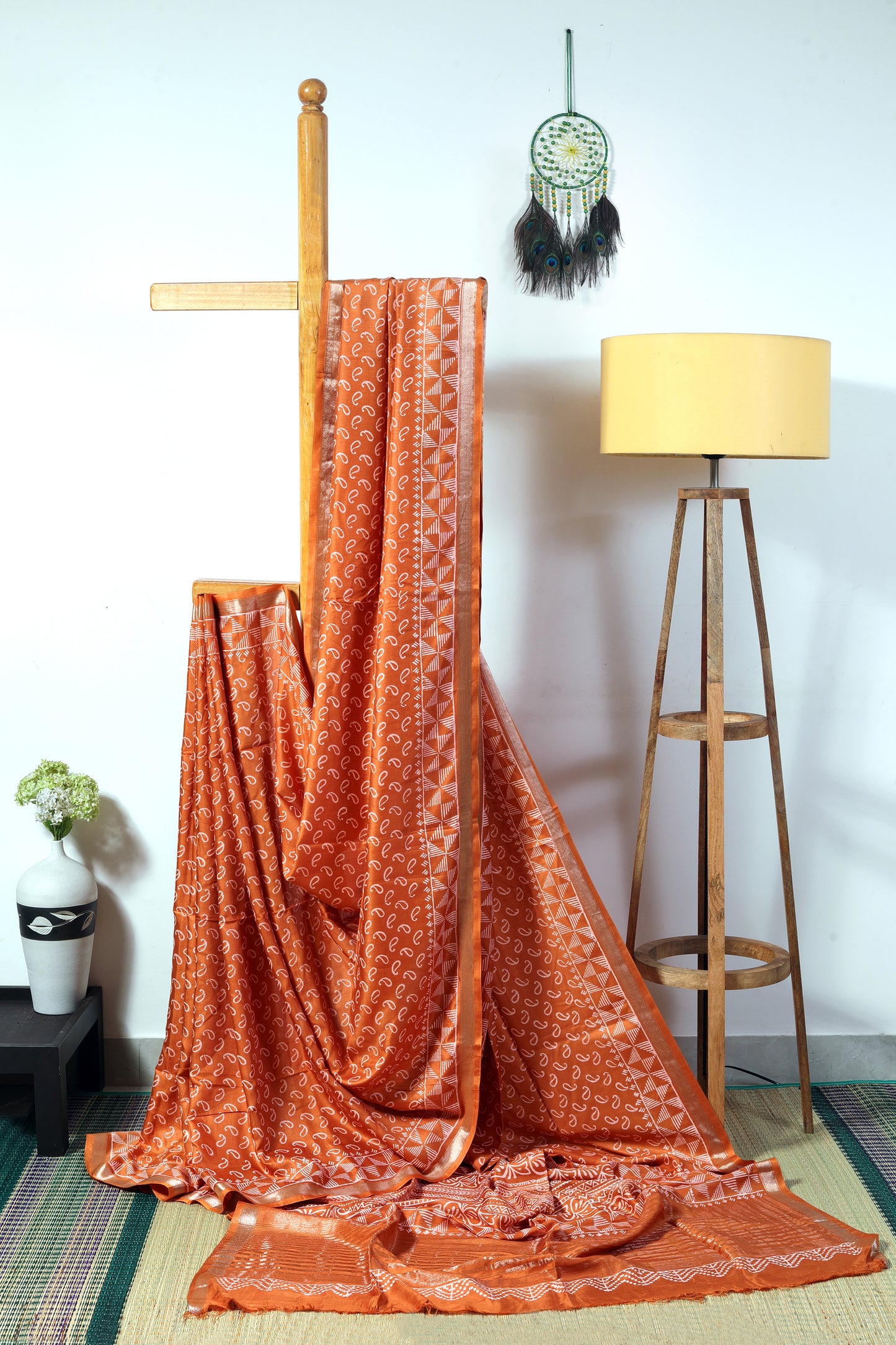 art silk crepe-  bronze color body with off white small mango block  prints finished with a geometrical patterned border and zari