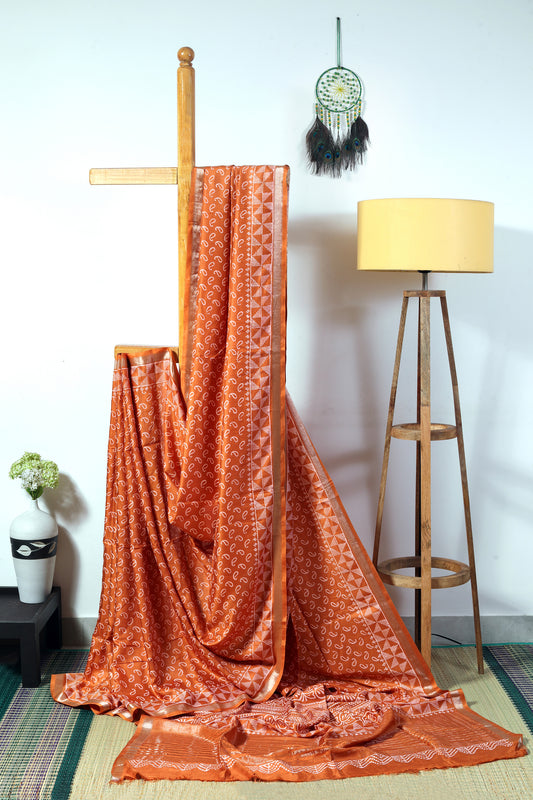 art silk crepe-  bronze color body with off white small mango block  prints finished with a geometrical patterned border and zari