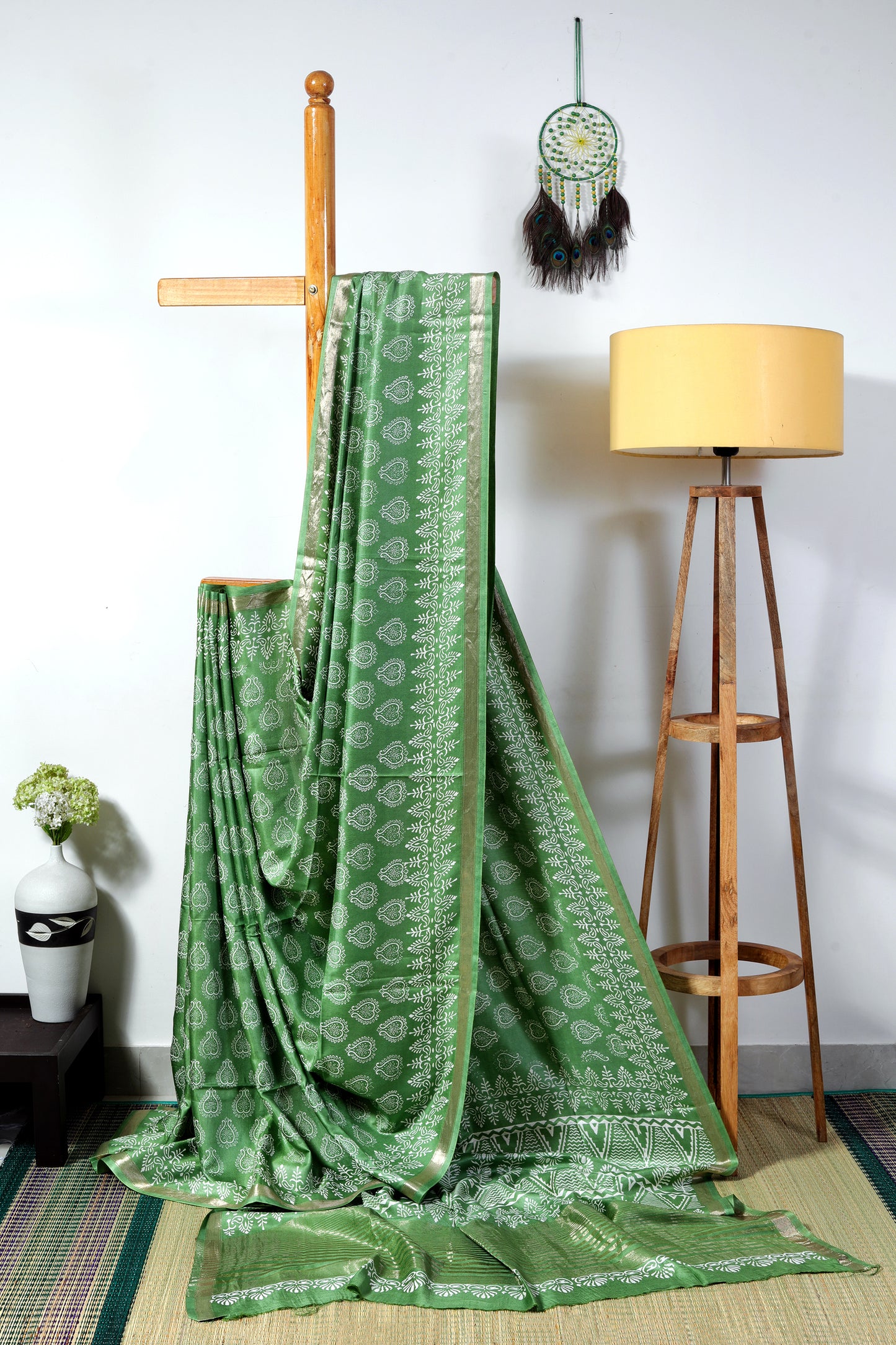 Silk Blend-  leaf green color with white heart like block prints with a floral patterned border and zari