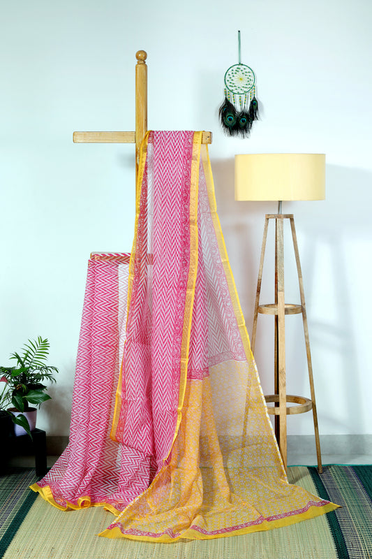 Breezy and playful pink zigzags paired with a bold yellow Bagru-printed border make this Kota Doria saree a charming and elegant choice