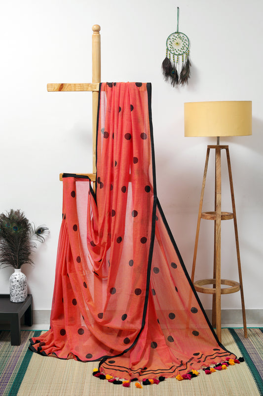 Mul Cotton - orange with polka dots in black with a black border