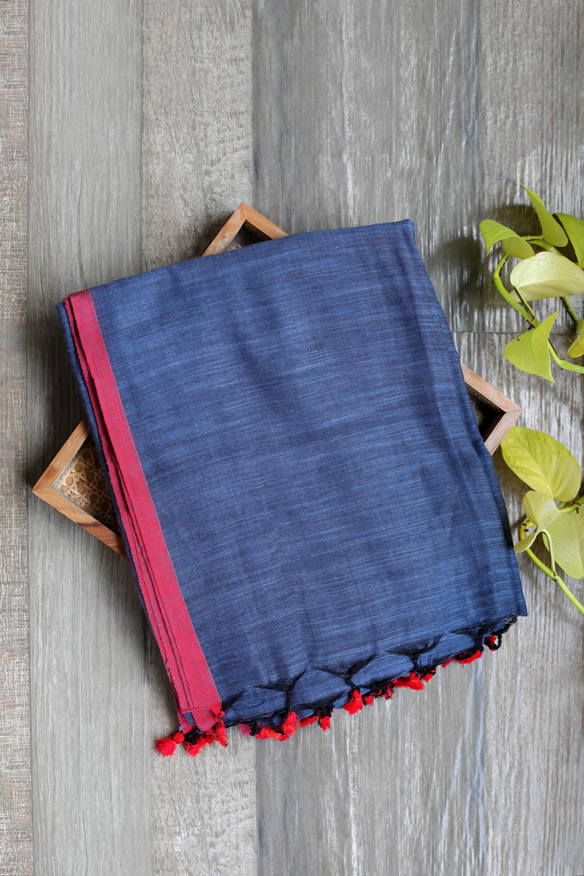 Soft cotton - grey   with a reddish border and red tassels