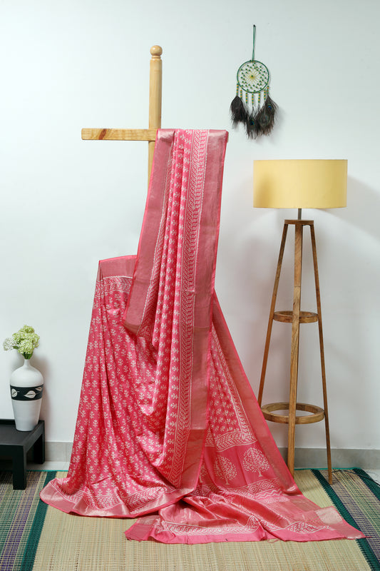art silk maheshwari - pinky peach body with small  plant like  block prints with a medium size zari border
